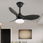 A black version of this Clérachic ceiling fan, with three matt black blades and a lit white light, in a bright modern room.