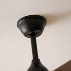 Close view of the black canopy and stem where this Clérachic ceiling fan meets the ceiling.