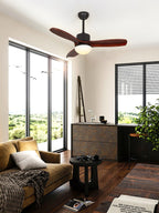 Dark brown ceiling fan with light from Clérachic in a living room with floor-to-ceiling windows and a mustard sofa.