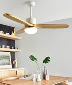 Lit ceiling fan from Clérachic with wooden blades above a wooden dining table, with open shelves and a monstera plant behind.