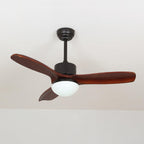 Black and dark brown ceiling fan with light from Clérachic, with deep red-brown blades and a lit frosted shade under a pale ceiling.