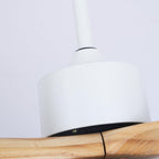 Close view of the white motor housing and the wood grain of a blade on this Clérachic ceiling fan.