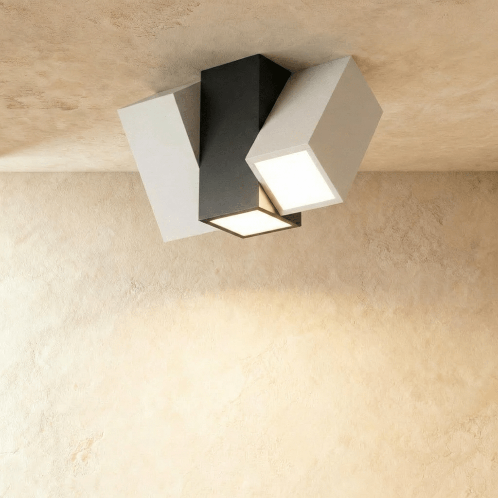 Clérachic three-head square-section ceiling light with a black centre block and two white angled heads, lit