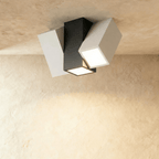 Clérachic three-head square-section ceiling light with a black centre block and two white angled heads, lit