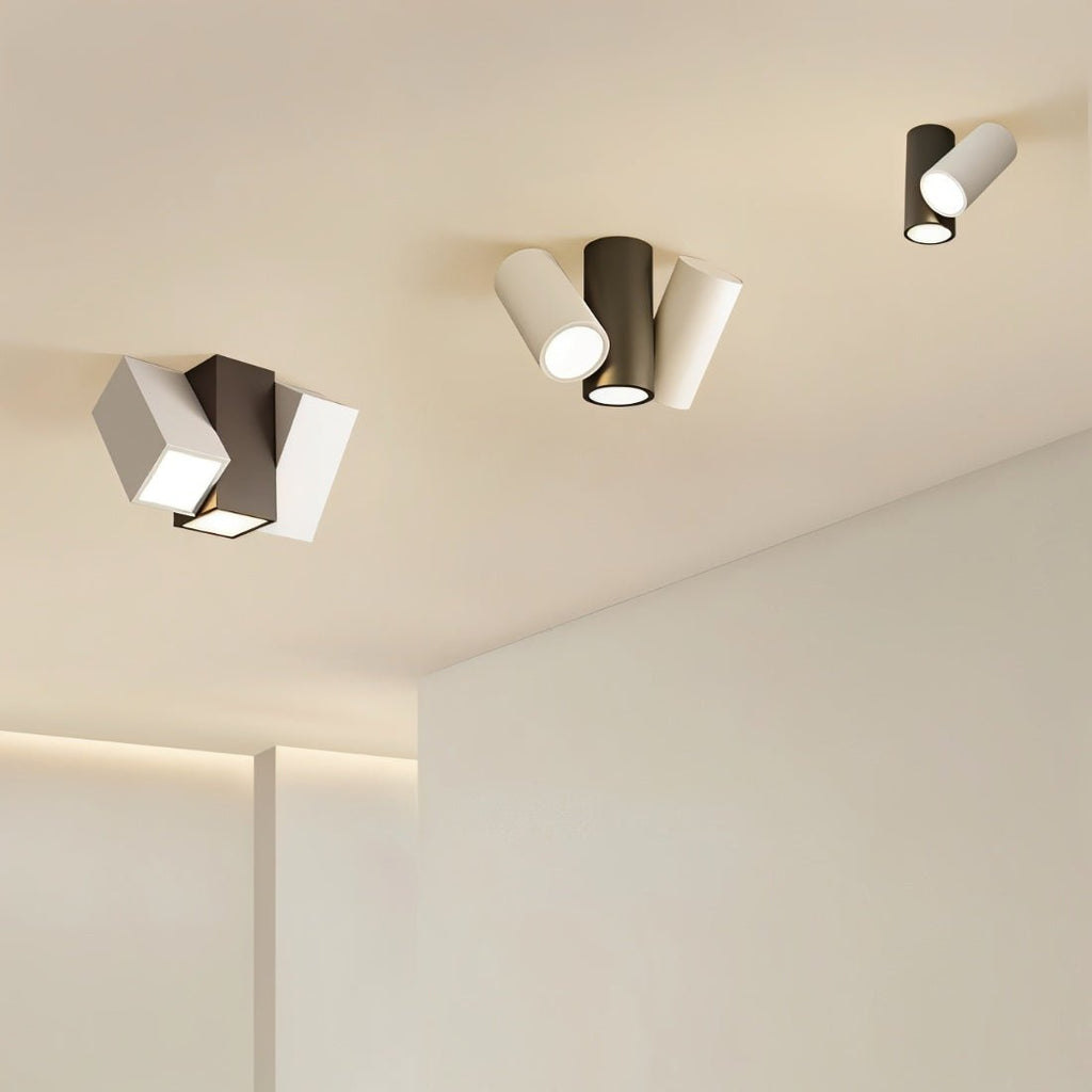 Clérachic ceiling lights in black and white, square and cylindrical heads, mounted across a pale ceiling
