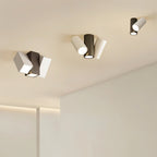 Clérachic ceiling lights in black and white, square and cylindrical heads, mounted across a pale ceiling
