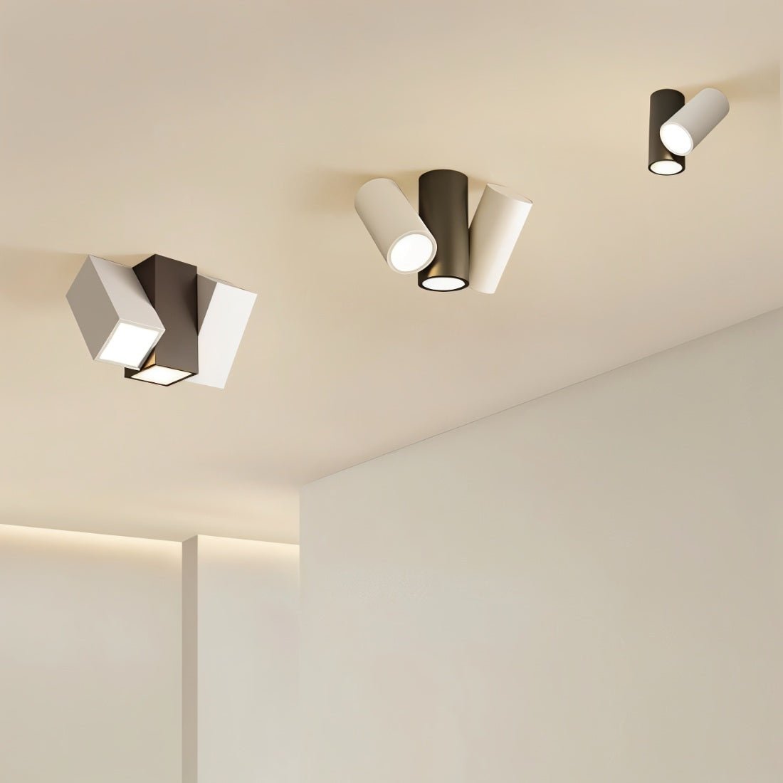 Clérachic ceiling lights in black and white, square and cylindrical heads, mounted across a pale ceiling