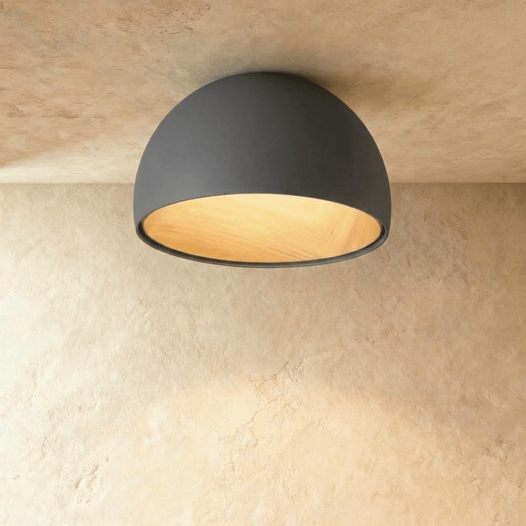 Clérachic grey domed ceiling light with a warm wood-grain interior, seen from below against a limewashed ceiling.