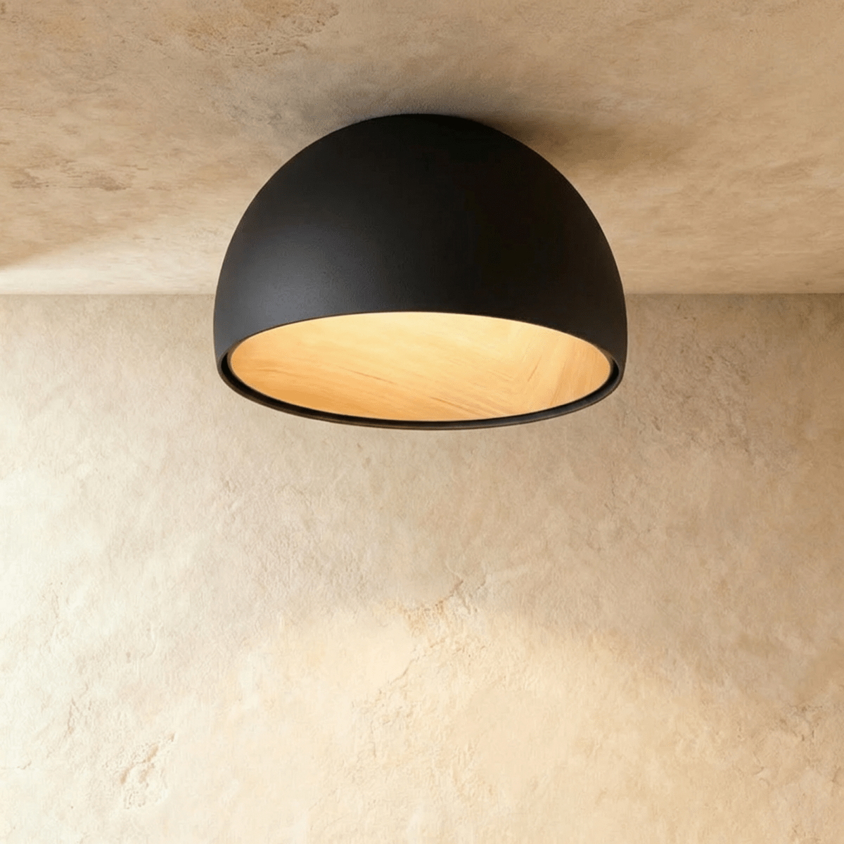 Clérachic black domed ceiling light with a warm wood-grain interior, seen from below against a limewashed ceiling.