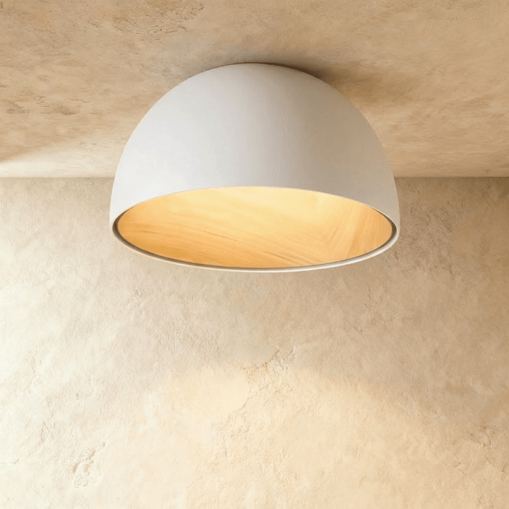 Clérachic larger white domed ceiling light with a wide wood-grain interior, fixed flush to a limewashed ceiling.