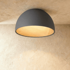 Clérachic larger grey domed ceiling light with a wood-grain interior, fixed flush to a limewashed ceiling.