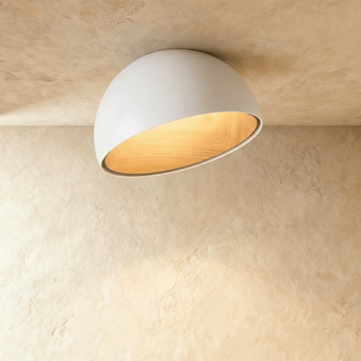 Clérachic white ceiling light with an angled, slanted-cut dome and a glowing wood-grain interior on a limewashed ceiling.