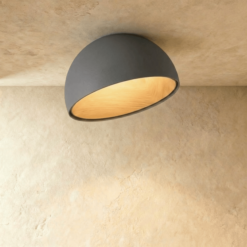 Clérachic grey ceiling light with an angled, slanted-cut dome and a warm wood-grain interior on a limewashed ceiling.
