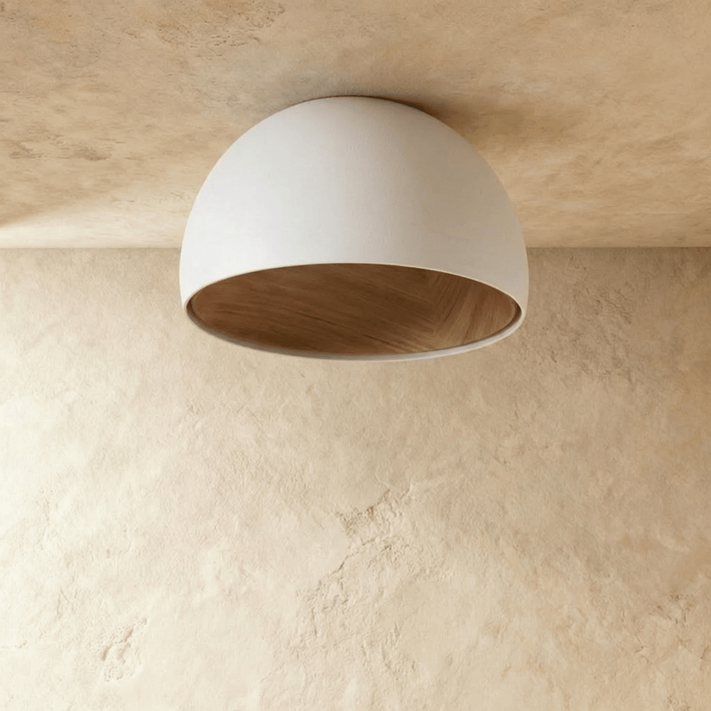 Clérachic white domed ceiling light switched off, showing the natural wood-grain lining inside its matt shade.