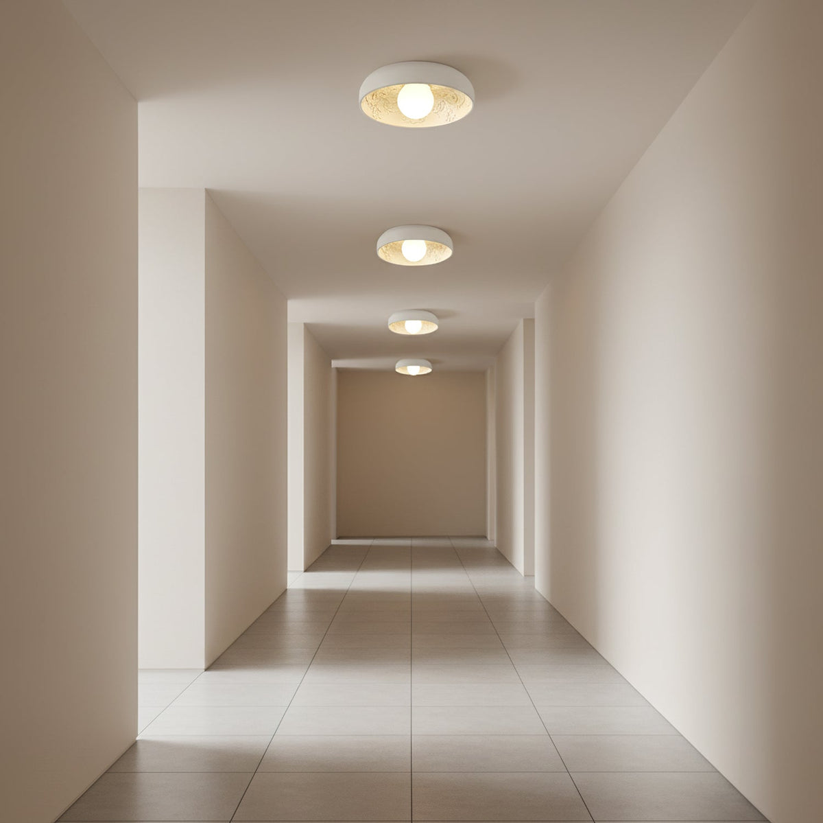 Clérachic flush-mount lights receding along a tiled corridor, each lit with a round globe inside a white bowl.