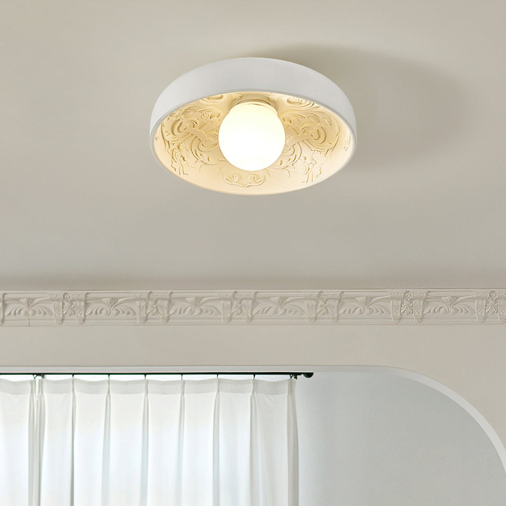 Clérachic white bowl light lit under a carved ceiling cornice, with a curtain rail and a rounded archway below.