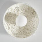 Looking straight up into this Clérachic bowl light, its carved acanthus-style relief radiating around the white globe.