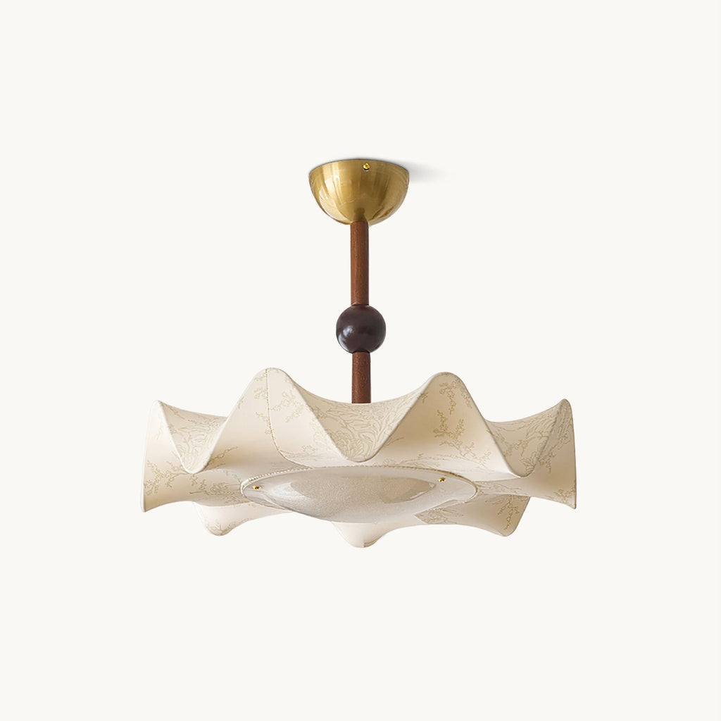 This Clérachic ceiling light on a plain white backdrop, with a brass canopy, a walnut-toned stem and a ruffled cream fabric shade.