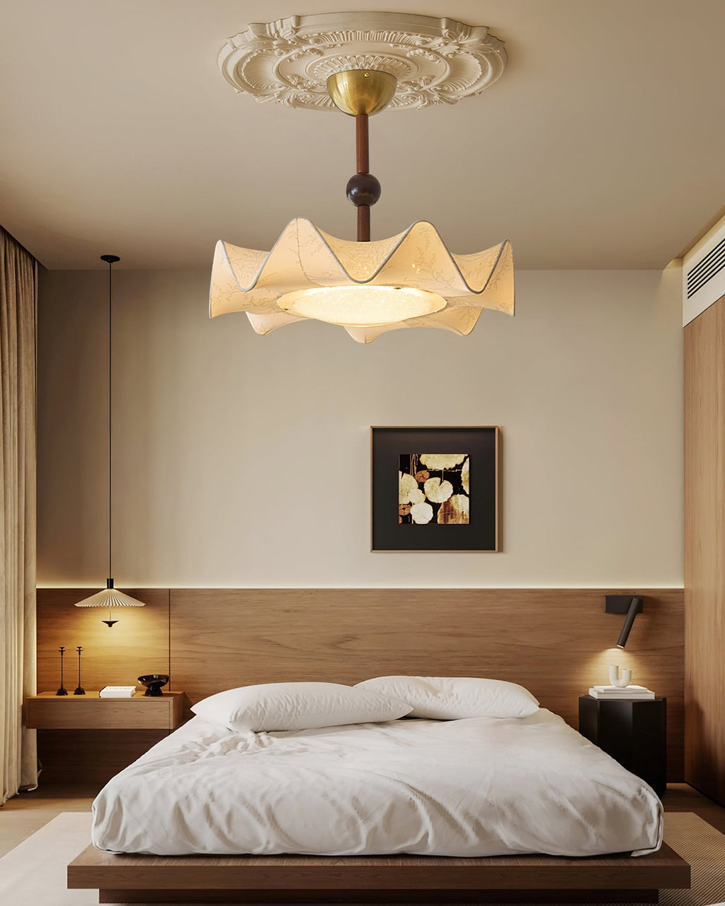A Clérachic ceiling light lit above a low wooden bed with white bedding, in a room with a dark wood headboard panel.
