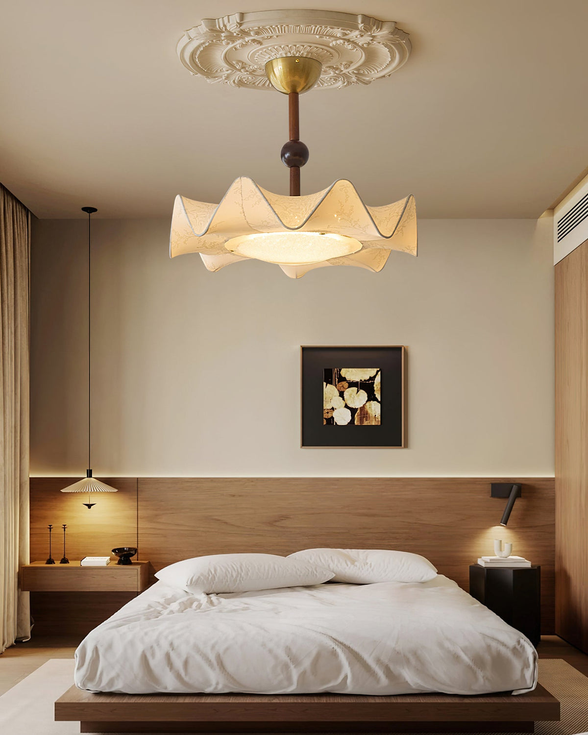 A Clérachic ceiling light lit above a low wooden bed with white bedding, in a room with a dark wood headboard panel.