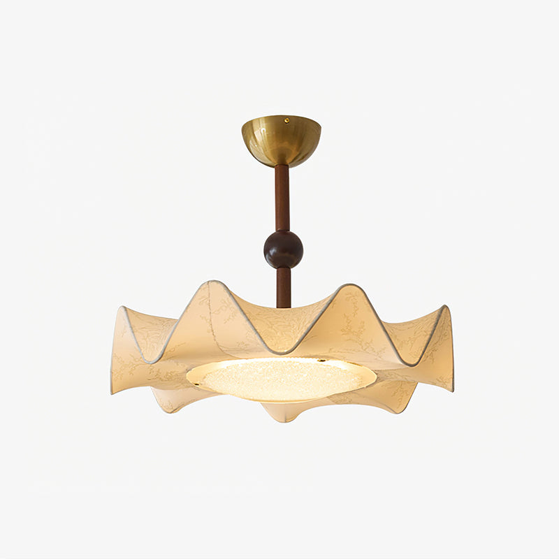 Clérachic ceiling light on a pale backdrop, lit, with its ruffled shade, brass canopy and a glowing frosted diffuser.