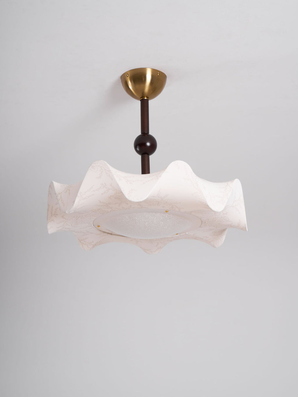Clérachic ceiling light unlit against a plain grey ceiling, with a brass canopy and a softly pleated cream shade.