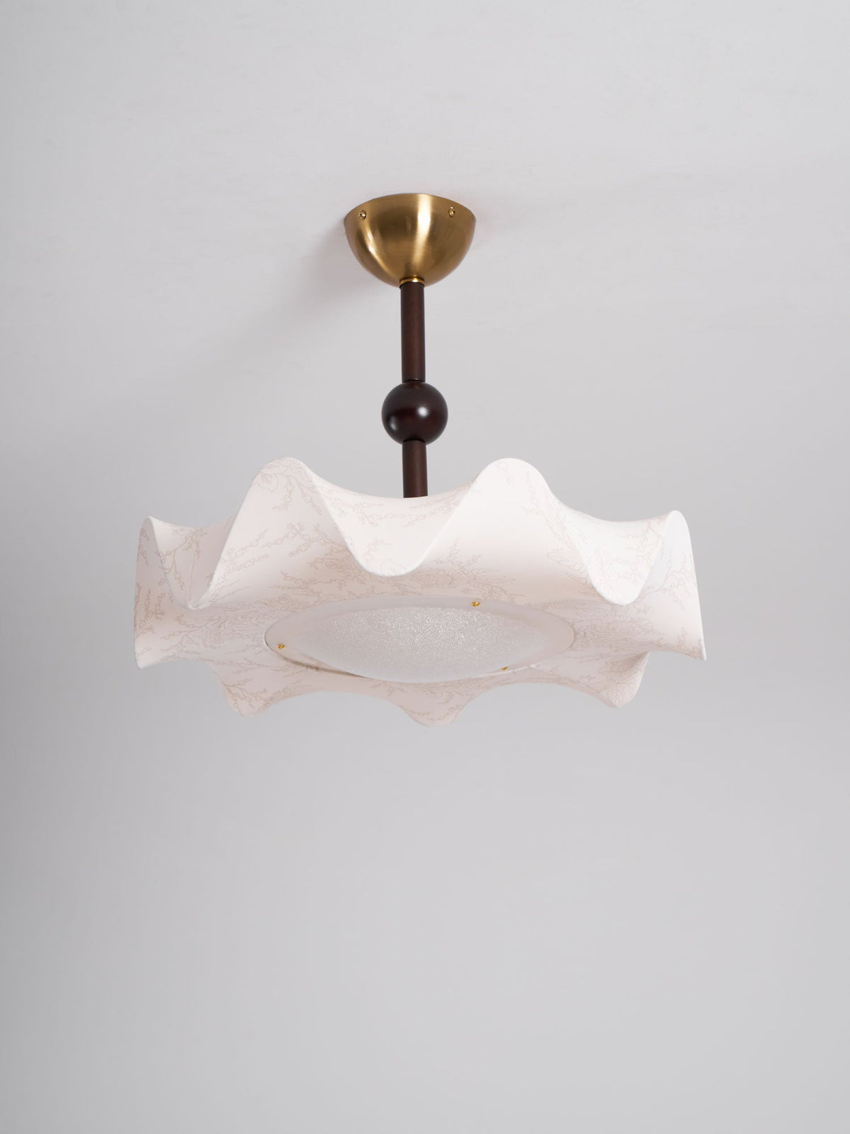 Clérachic ceiling light unlit against a plain grey ceiling, with a brass canopy and a softly pleated cream shade.