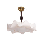 Clérachic ceiling light on a white backdrop, unlit, with a brass canopy, a dark wooden ball and a ruffled cream shade.
