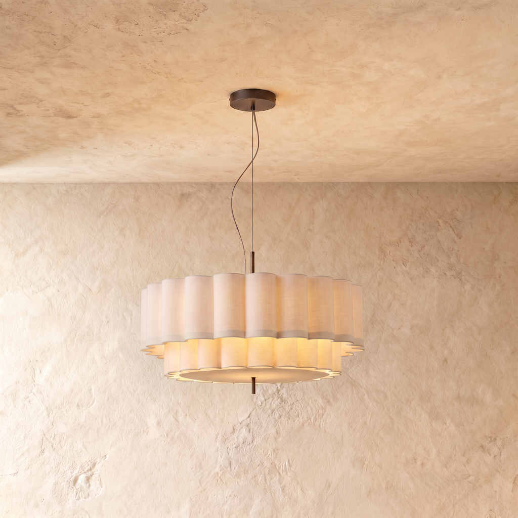 This Clérachic ceiling pendant hangs a two-tier scalloped fabric drum shade from a slim rod against plaster.
