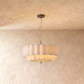 This Clérachic ceiling pendant hangs a two-tier scalloped fabric drum shade from a slim rod against plaster.