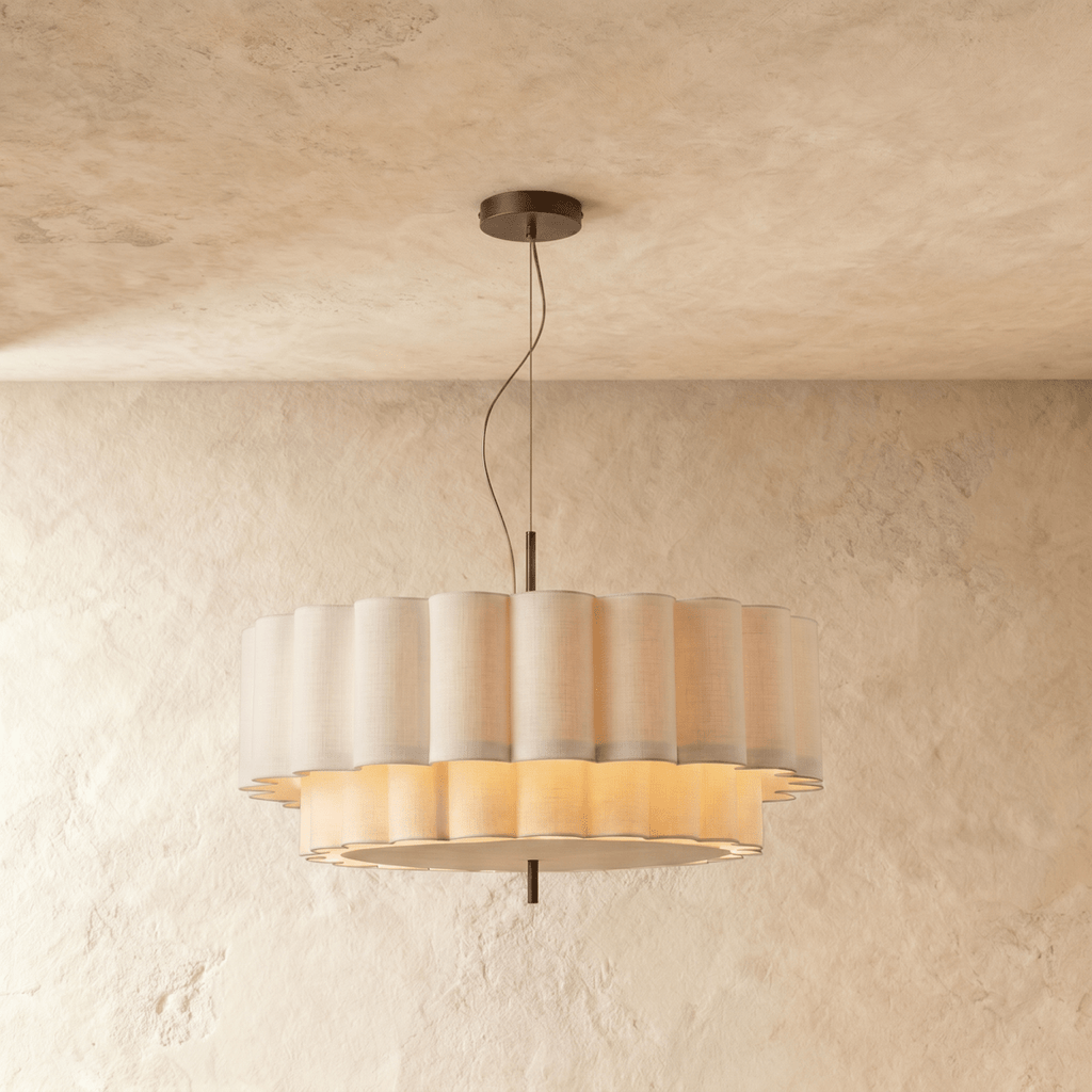 A Clérachic pendant light's ribbed fabric drum glows from within, its two tiers softly lit.