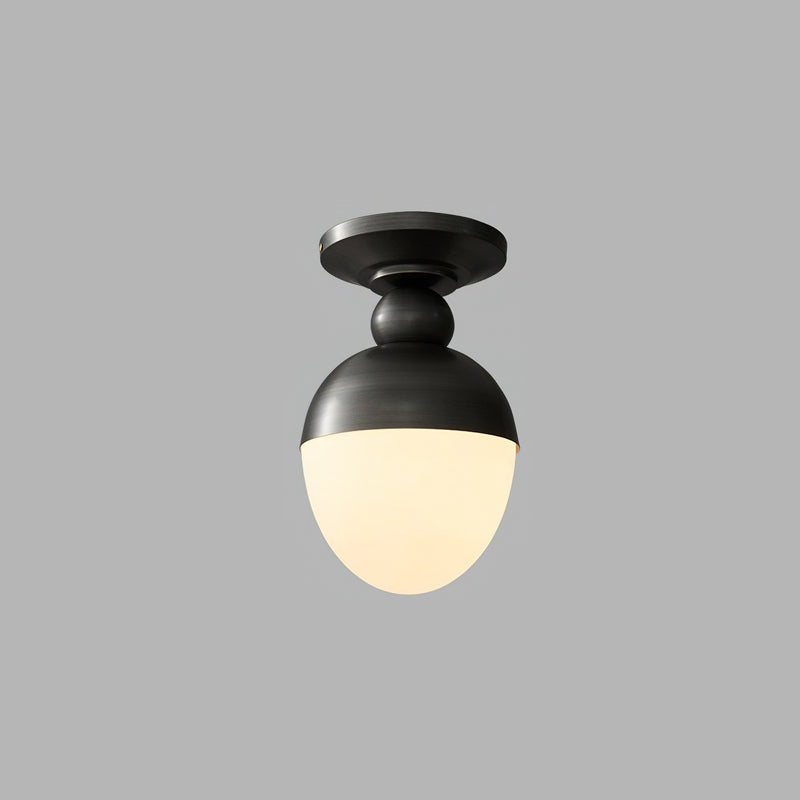 The black and white version of this Clérachic ceiling light, lit warm, with a dark metal cap and ball joint on a plain grey backdrop.