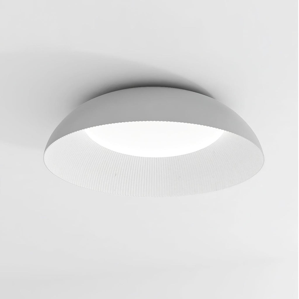 Close view of the grey dome and finely ribbed white interior of this Clérachic ceiling light, with its LED diffuser glowing.