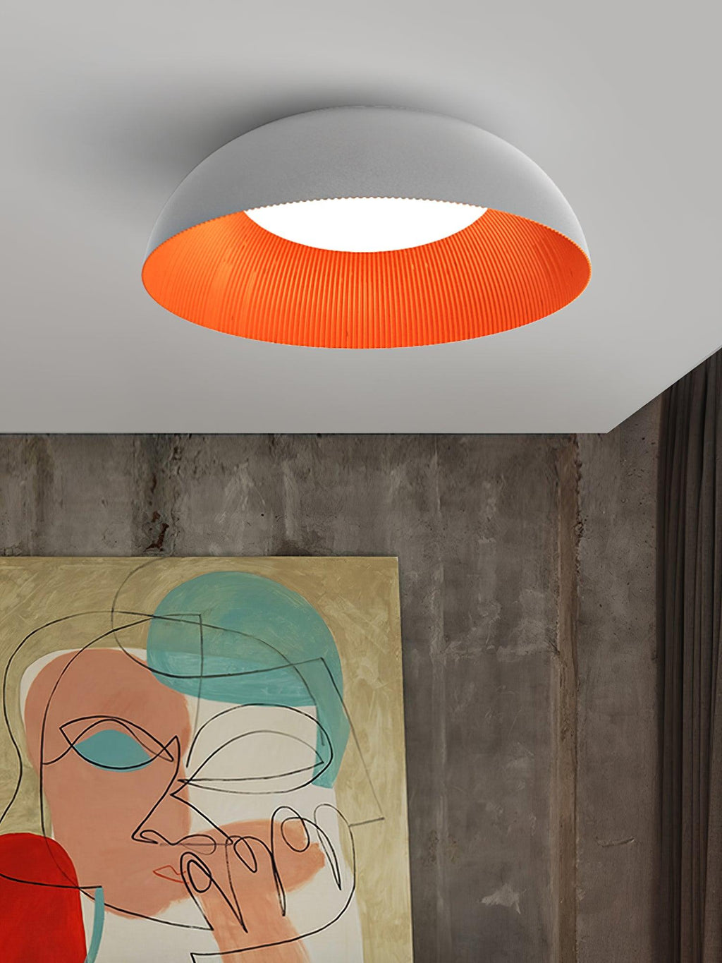 Grey and orange dome ceiling light from Clérachic above a concrete-look wall and a large abstract face painting.