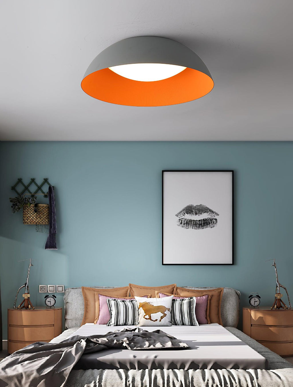 Grey dome with orange inner rim over a bed with striped cushions and a horse pillow, against a blue wall, from Clérachic.