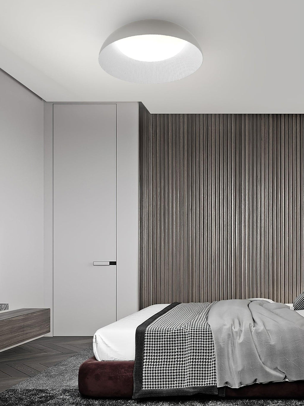 Pale dome ceiling light from Clérachic with a bright white diffuser above a bed, with a slatted wood wall and a dark-red base.