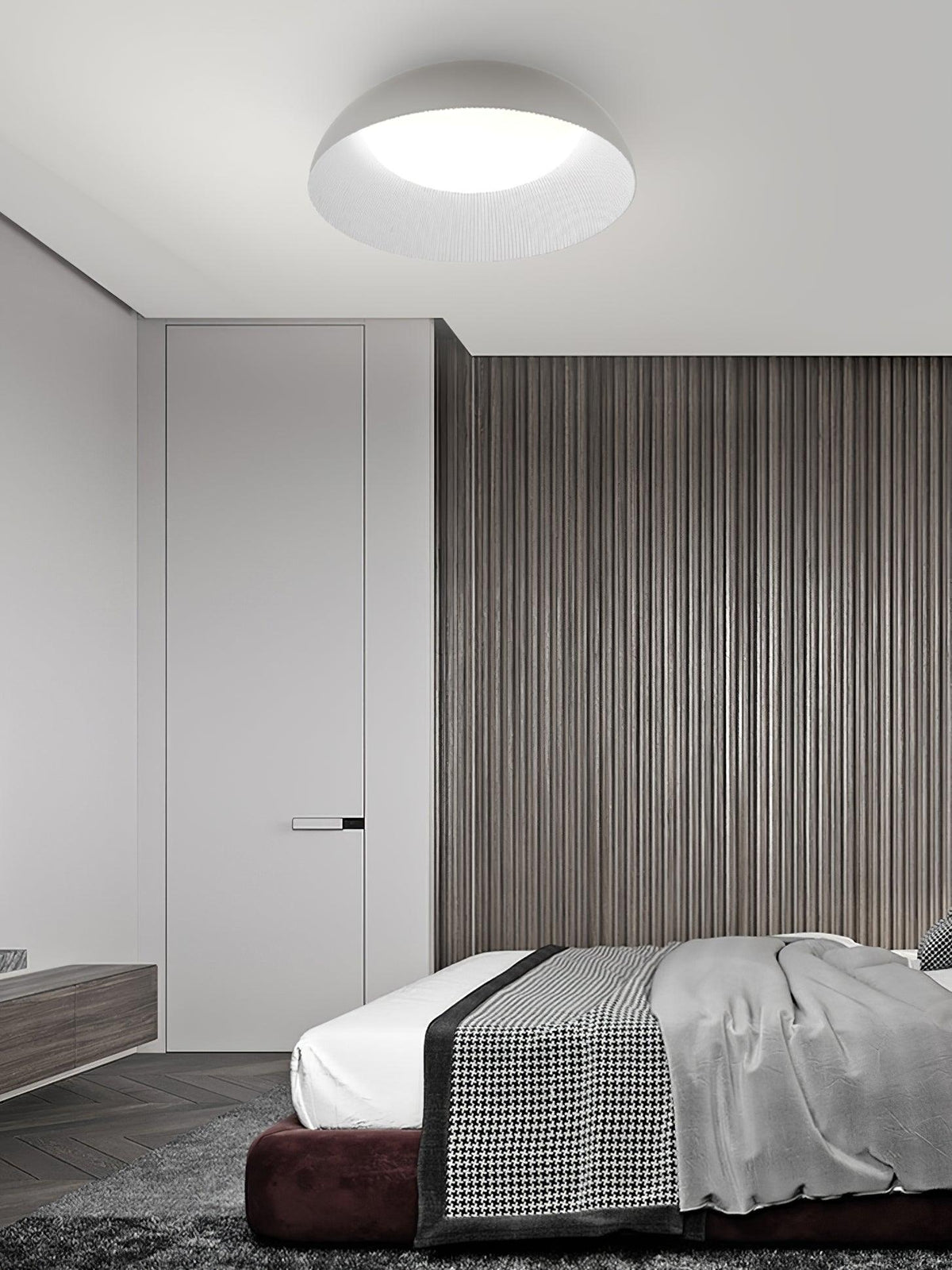 Pale dome ceiling light from Clérachic with a bright white diffuser above a bed, with a slatted wood wall and a dark-red base.