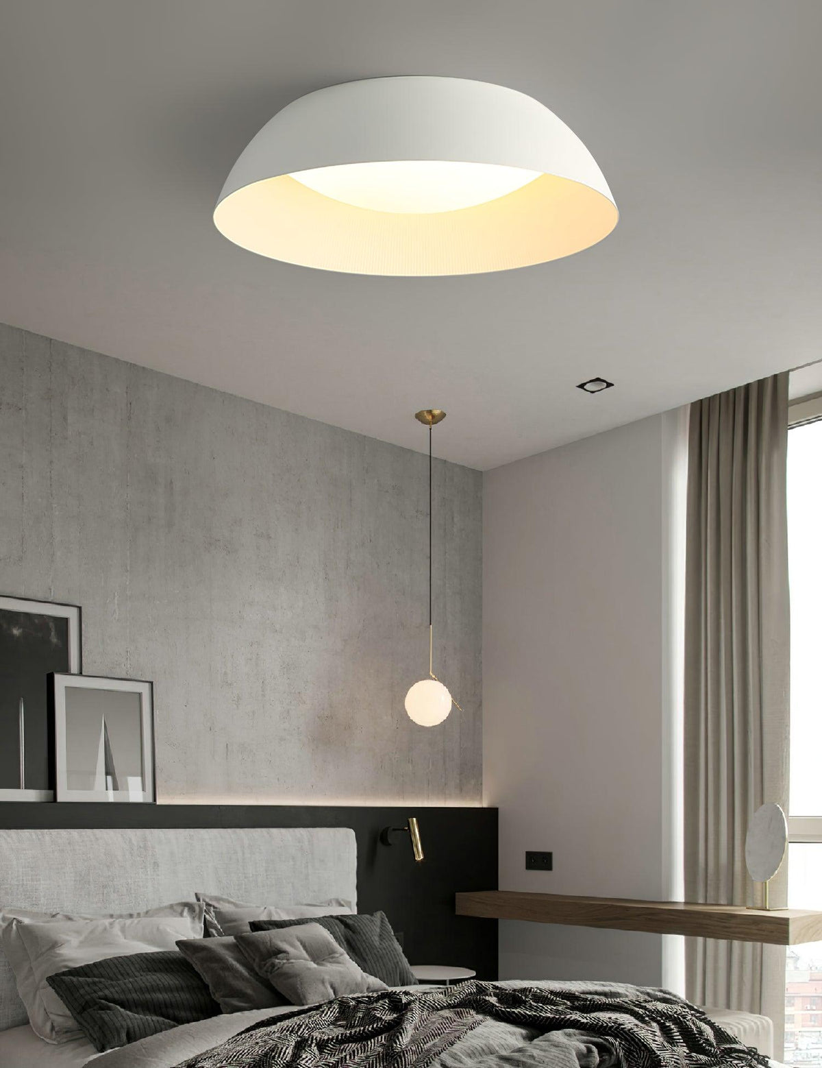 White dome with a warm-glowing interior above a dark bedroom with a pendant globe light and a concrete-look wall, from Clérachic.