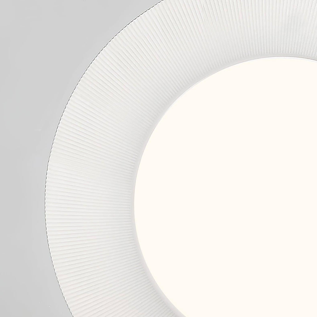 Detail of the finely ribbed white ring around the glowing round diffuser of this Clérachic ceiling light.