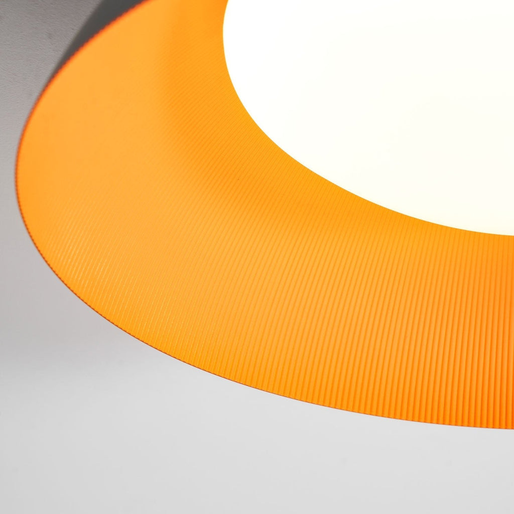 Close view of the bright orange ribbed interior around the white diffuser on this Clérachic ceiling light.