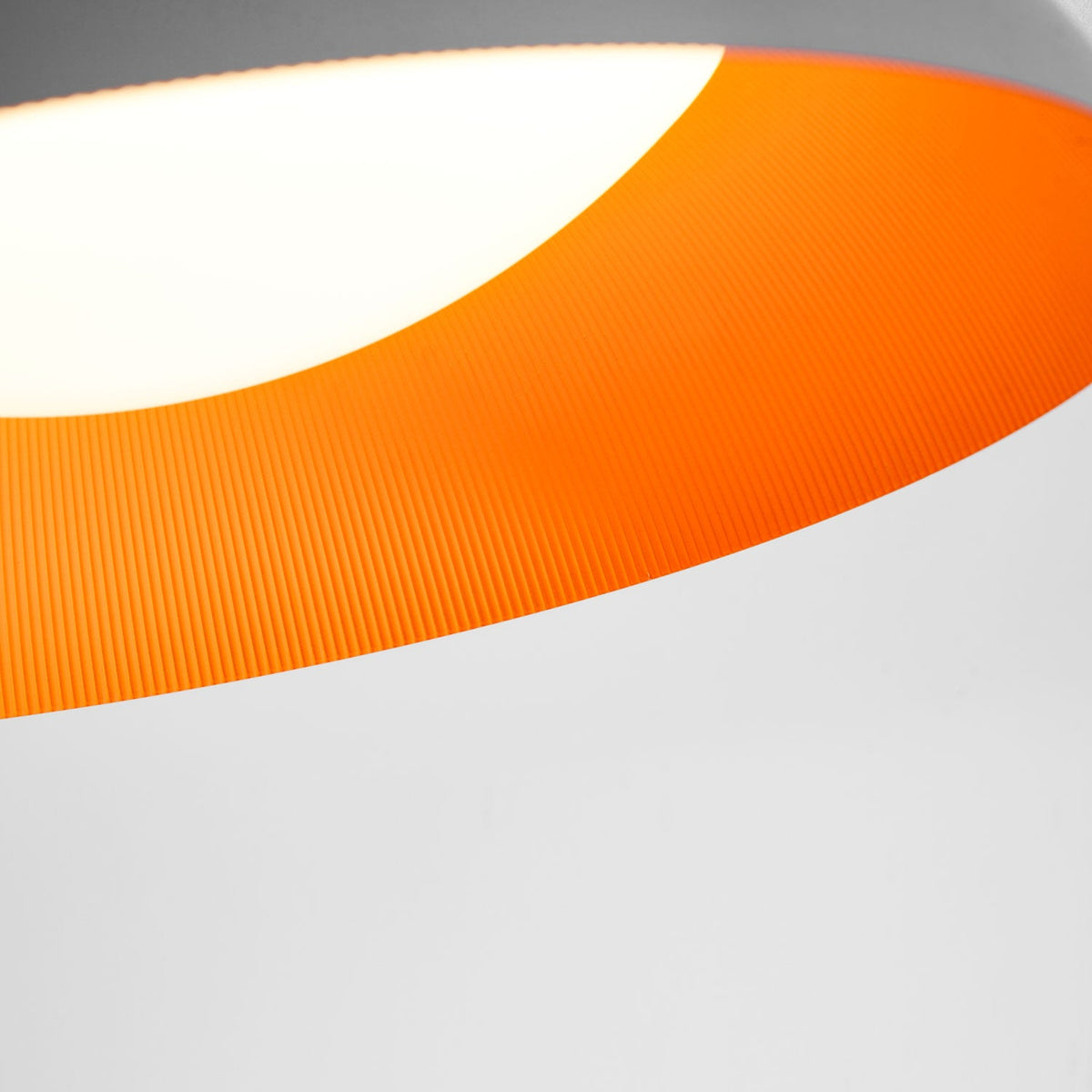 Detail of the orange-ribbed interior and curved white diffuser of this Clérachic ceiling light, with the grey rim above.