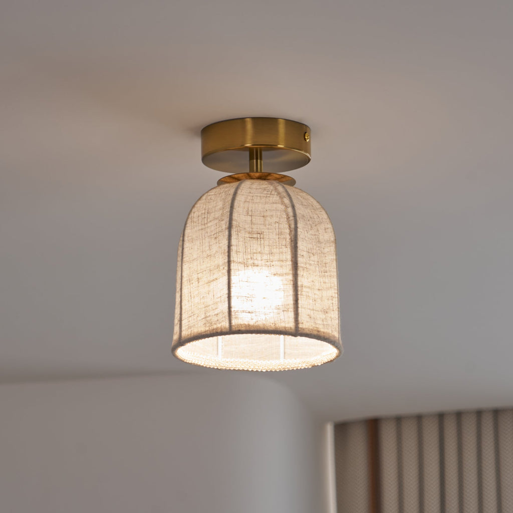 This Clérachic ceiling light on a cooler setting, its linen shade glowing pale beside a striped curtain.