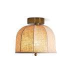 Clérachic wide flush-mount ceiling light with panelled linen shade lit from within, a gold canopy above and a small gold bead beneath.