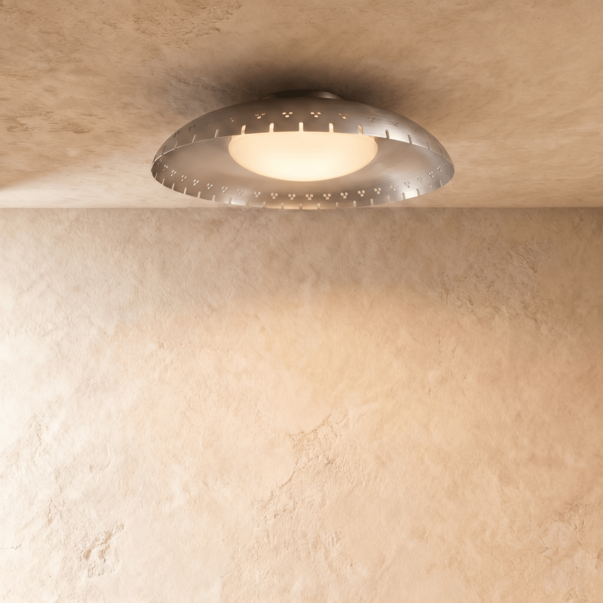 Clérachic ceiling light in chrome, its slotted metal rim reflecting soft light on a plaster ceiling.