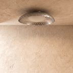 Clérachic ceiling light in chrome viewed at an angle, the perforated rim catching a cool metallic sheen.