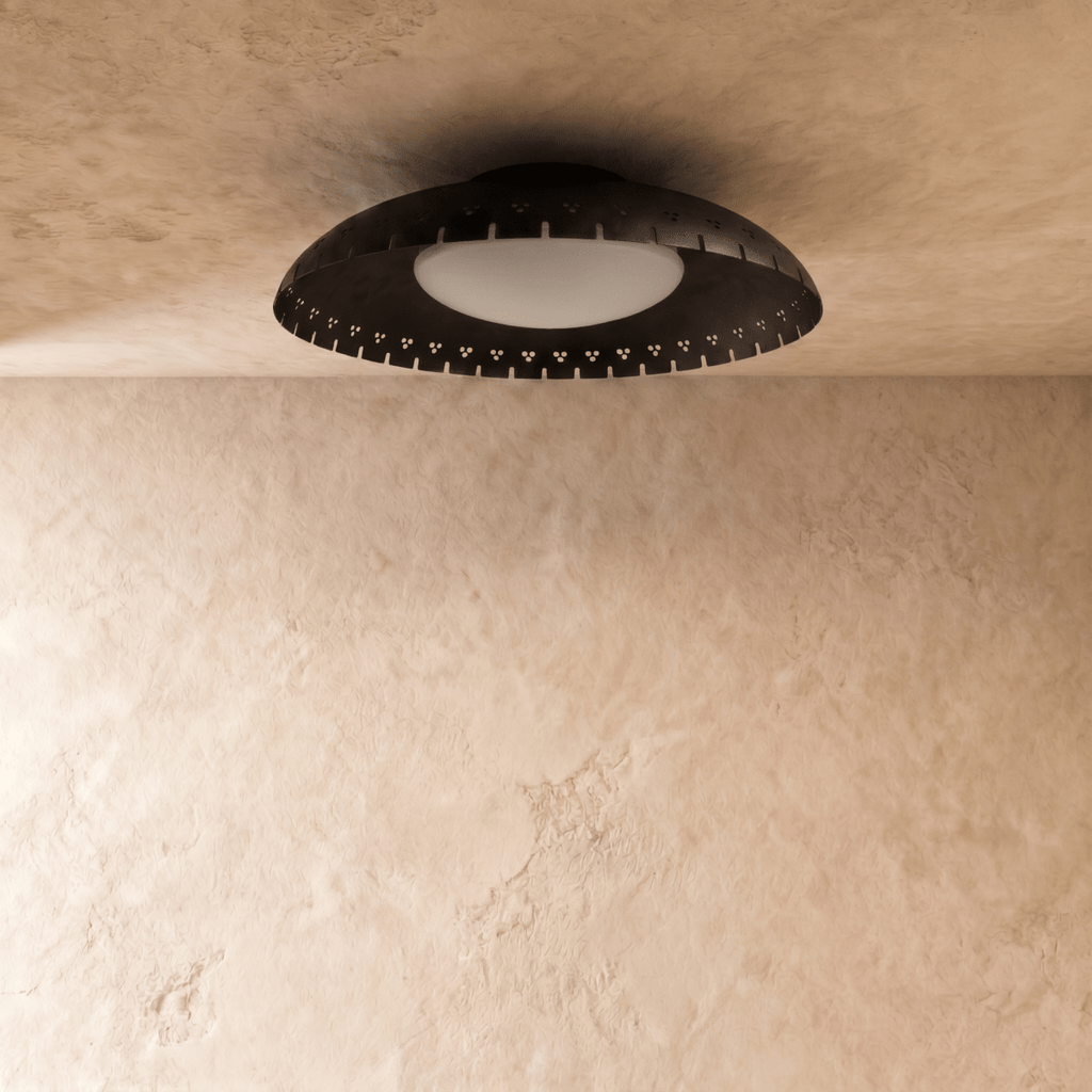 Clérachic ceiling light in matte black shown close, its frosted glass diffuser glowing warm beneath the rim.