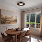 Clérachic ceiling light in matte black lighting a dining room hung with a framed landscape painting.