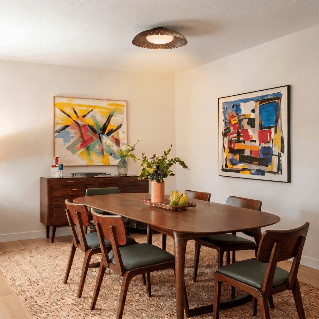 Clérachic ceiling light in matte black above a walnut dining table surrounded by bold abstract paintings.