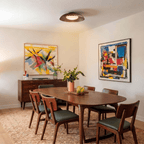 Clérachic ceiling light in matte black above a walnut dining table surrounded by bold abstract paintings.