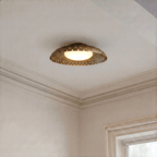 Clérachic ceiling light in vintage brass glowing in a corner near a paneled doorway and crown molding.
